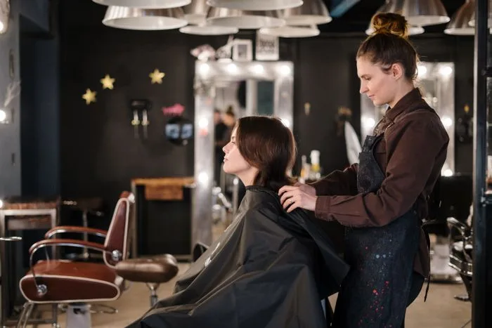 A hair styling session in a calm, neutral-toned salon