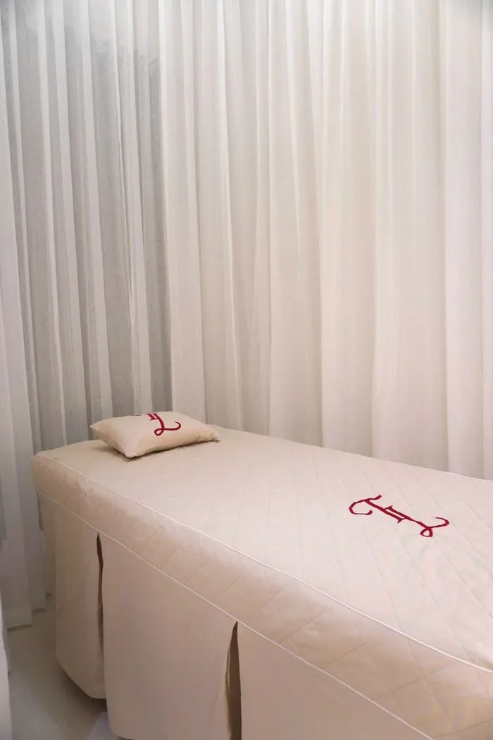 A massage table prepared with fresh linen