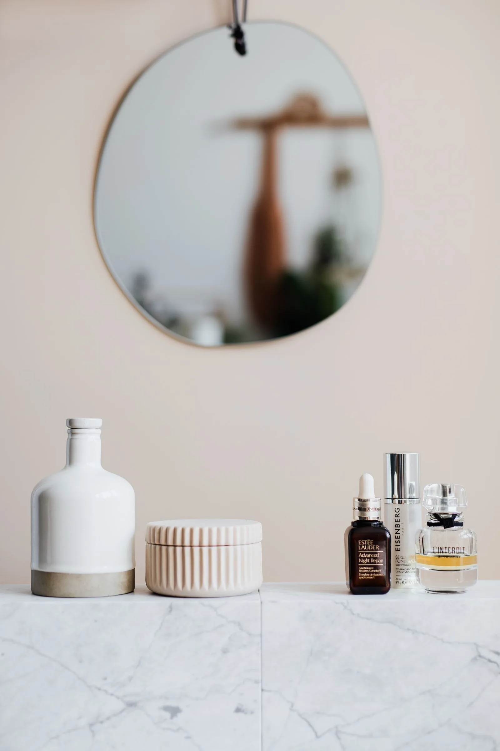 Natural skincare products arranged on a stone surface in warm light