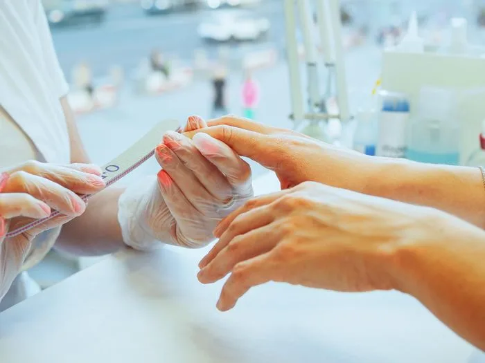 Close-up of a manicure treatment with natural tone polish