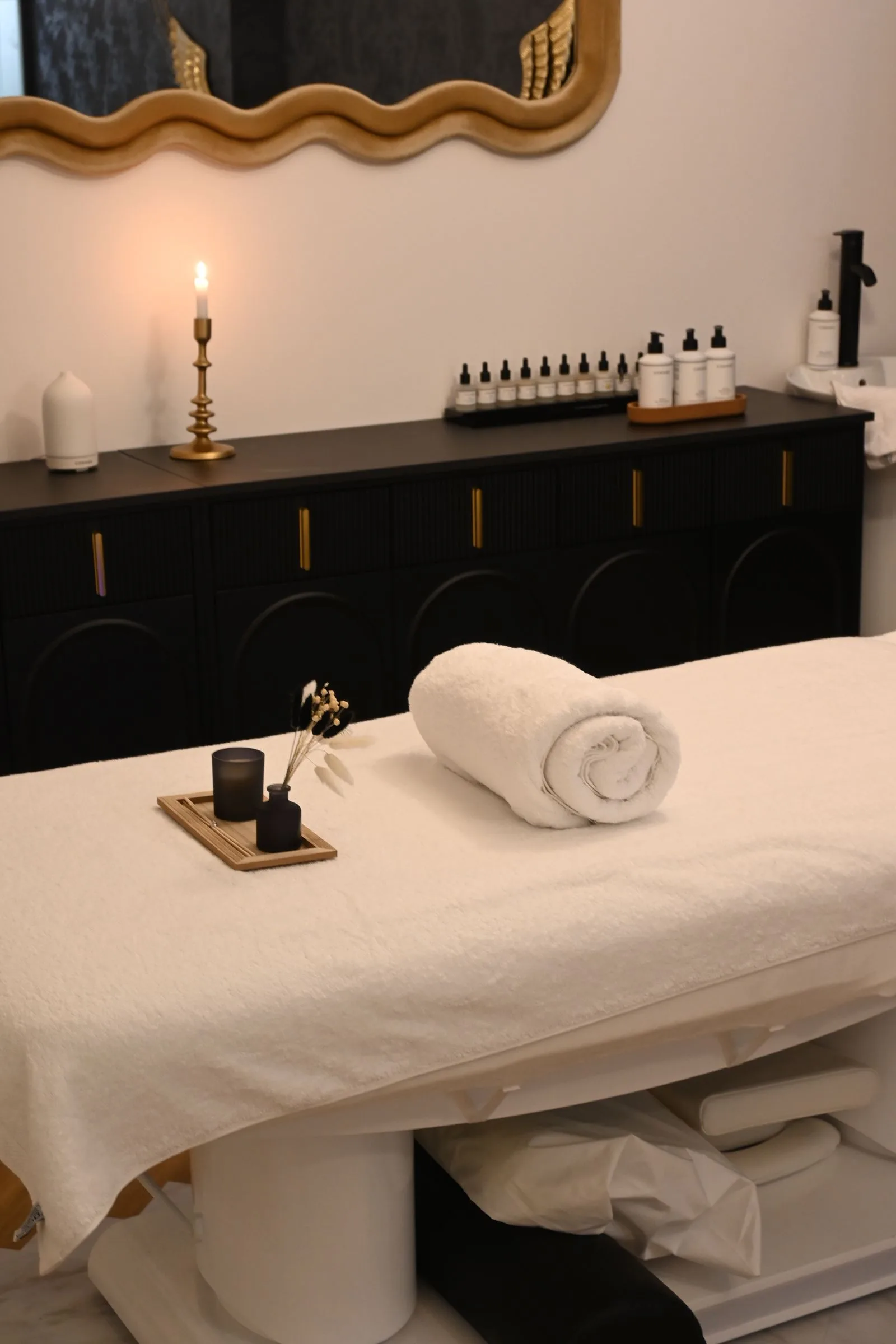 Warm towels, botanicals and a stone bowl prepared for the Aurelia Body Ritual
